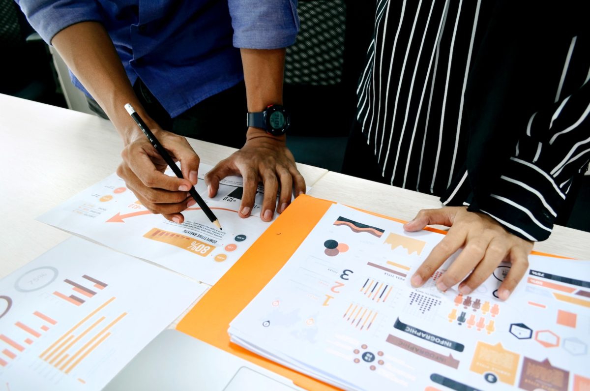 post image A team analyzing reports of brand awareness metrics including reach and engagement